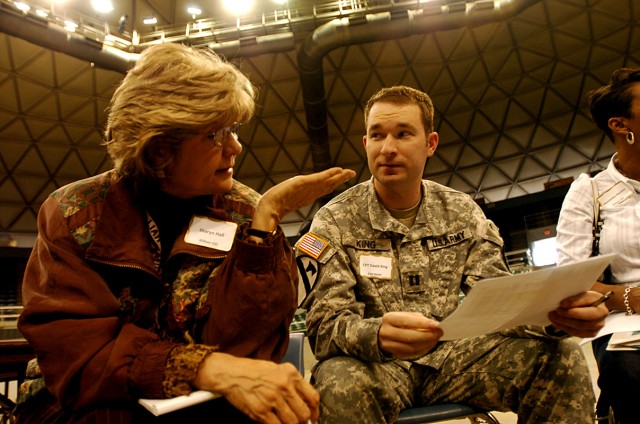Capt. David King, 1st Cavalry Division Rear Detachment's Communications officer, speaks with Sharyn Hall, Killeen High School's Student Activities coordinator, during a meeting between 1st Cav. Div. and Central Texas high school reps March 31, at the...