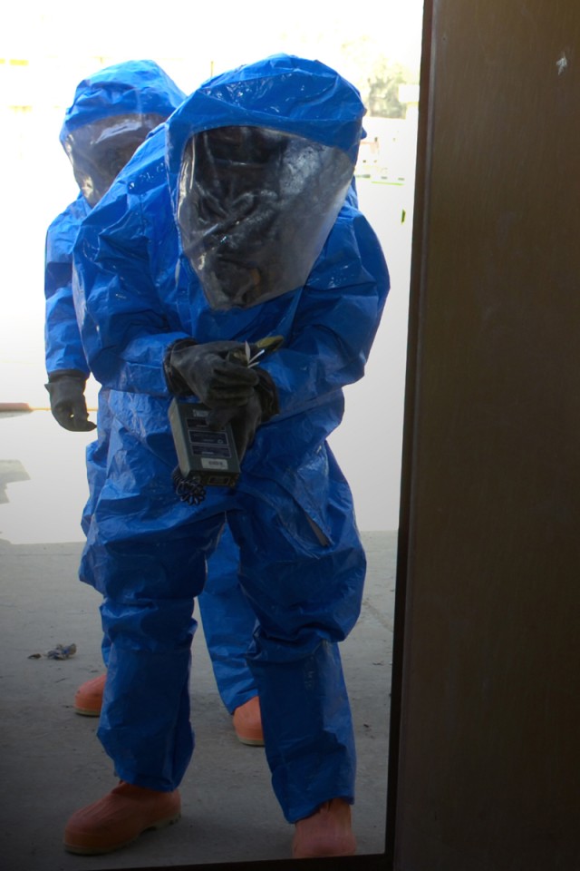 Soldiers from Chemical, Biological, Radiological, and Nuclear Plt., Headquarters and Headquarters Company, 3rd Heavy Brigade Combat Team, 1st Cavalry Division, get toxicity readings before entering a possibly contaminated building as part of their...