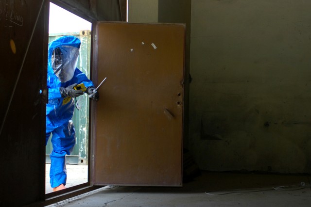 A Soldier from Chemical, Biological, Radiological, and Nuclear Plt., Headquarters and Headquarters Company, 3rd Heavy Brigade Combat Team, 1st Cavalry Division, checks the contamination levels of a area before entering a room during a training...