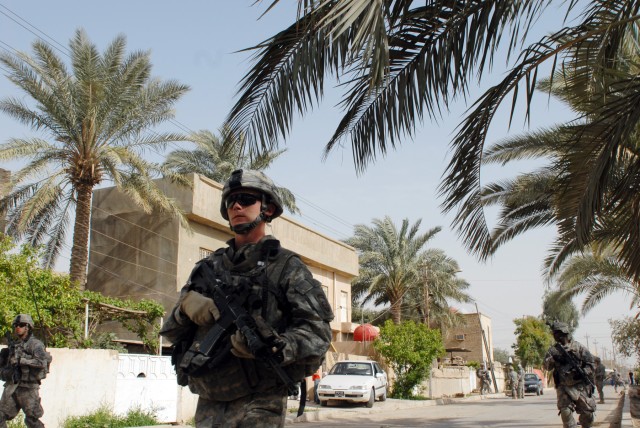 BAGHDAD - Spc. Bradley Jennings, a cannon crewmember from Welling, Okla., assigned to 3rd Platoon, B Battery, patrols the streets of the Karrada district of southeastern Baghdad, March 28. Jennings and his fellow paratroopers do daily patrols to...