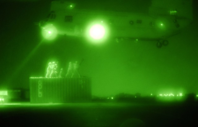 BAGHDAD- Soldiers of Company A, 47th Forward Support Battalion, 2nd Brigade Combat Team, 1st Armored Division, Multi-National Division-Baghdad, conduct night time sling load training. Soldiers hook a storage container to the bottom of a Chinook durin...