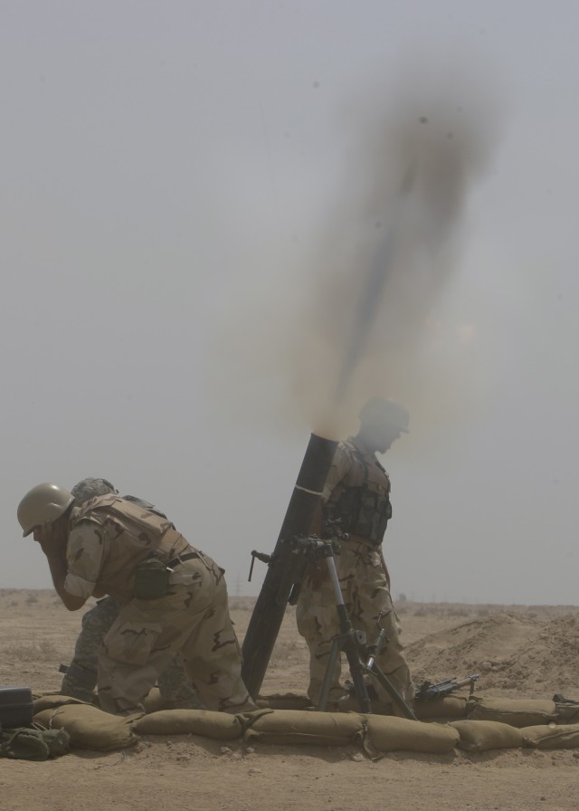 BAGHDAD- Soldiers from the 17th Iraqi Army Division fire 120 mm mortars during a combined arms live-fire exercise, air assault operation, and crowd control procedures at the Qaqa' weapons facility south of Baghdad April 6.  The exercise was to demons...