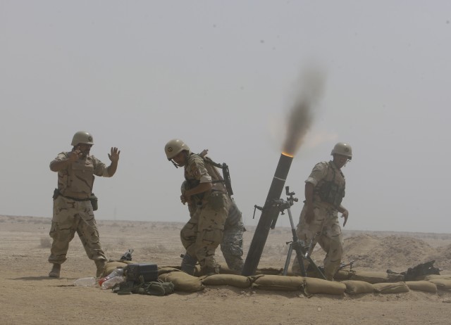 BAGHDAD- Soldiers from the 17th Iraqi Army Division fire 120mm mortars during a combined arms live-fire exercise, air assault operation and crowd control procedures at the Qaqa' weapons facility south of Baghdad April 6.  The exercise was conducted t...