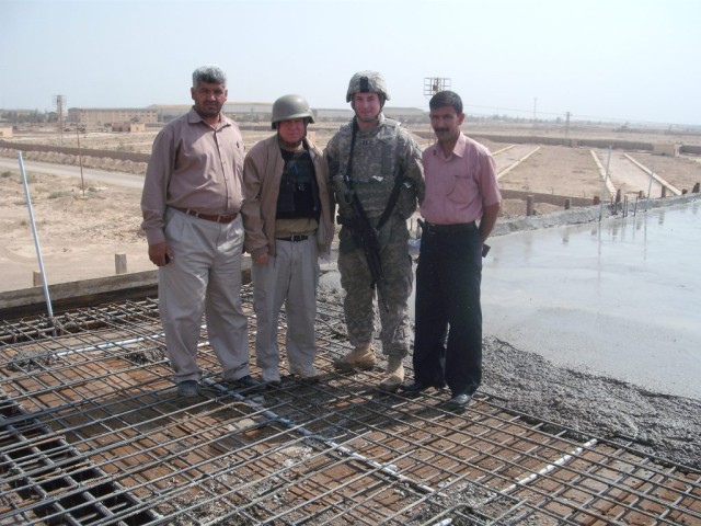 BAGHDAD -  Winner of the Brig. Gen. Edmund Giering III outstanding company commander award, Capt. Jackie Manton of Ponchatoula, La., meets with project managers of the Nasir Wa Salam fire station project. Manton, a member of the 225th Engineer...