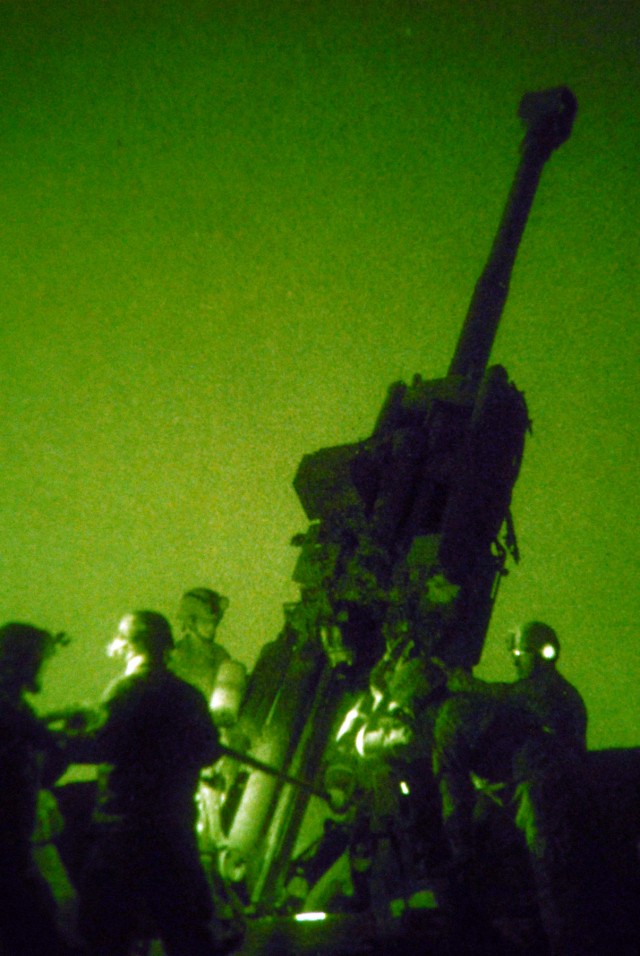 BAGHDAD - Soldiers from Bravo Battery, 1st Battalion "Arrowhead," 109th Field Artillery Regiment, 56th Stryker Brigade Combat Team, load 155mm illumination rounds or "candles" into the M777A2 Howitzer gun at JSS Istaqlal here April 11. The "Arrowhead...