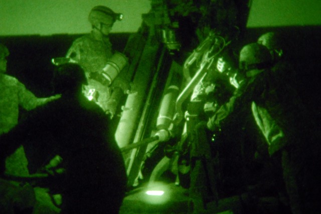 BAGHDAD - Soldiers from Bravo Battery, 1st Battalion "Arrowhead," 109th Field Artillery Regiment, 56th Stryker Brigade Combat Team, load a 155mm illumination round into the M777A2 Howitzer gun at JSS Istaqlal here April 11. To fire the gun, an eight-...
