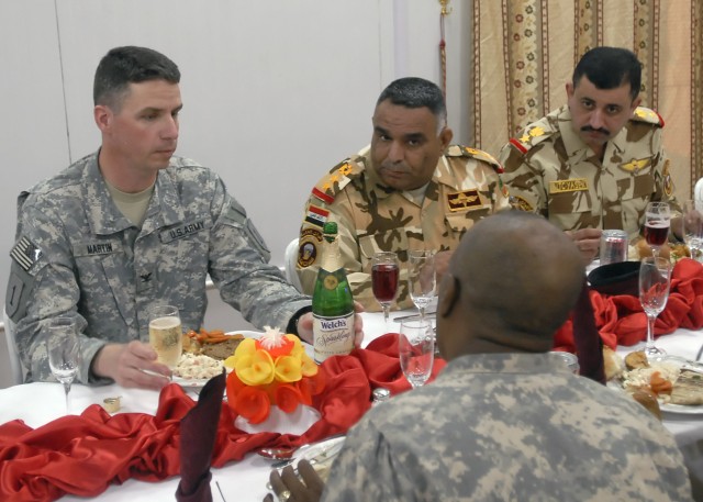 BAGHDAD - Dearborn, Mich. native Col. Joseph Martin, commander, 2nd Heavy Brigade Combat Team "Dagger," 1st Infantry Division, Multi National Division - Baghdad, meets with leaders of the 24th Brigade, 6th Iraqi Army Division for dinner at the...