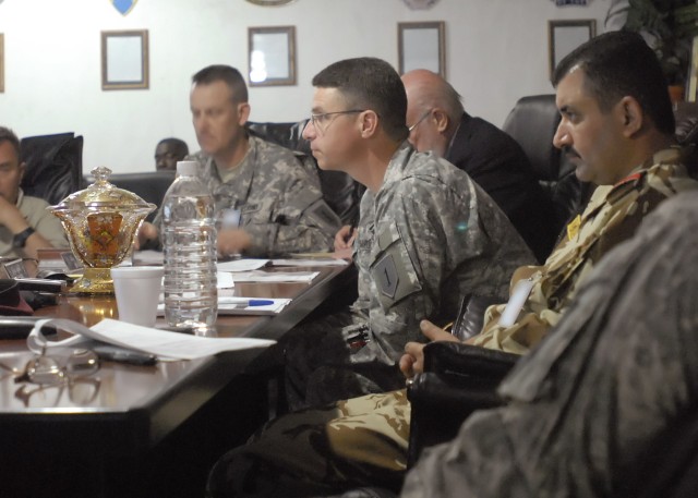 BAGHDAD - Dearborn, Mich. native, Col. Joseph Martin (center, with glasses), commander, 2nd Heavy Brigade Combat Team "Dagger," 1st Infantry Division, Multi National Division - Baghdad, and Lt. Col. Yasser, 24th Brigade, 6th Iraqi Army Division, sit ...