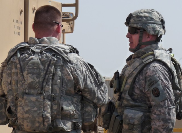BAGHDAD - After the convoy briefing with the 46th "Steel Spike" Engineer Battalion, newly-assigned Multi-National Corps Iraq Command Sgt. Major, Frank Grippe (right), a native of Frankfort, N.Y., gears up for an up close and personal tour with the co...