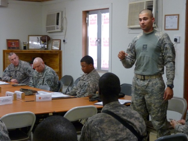 BAGHDAD - Mesa, Ariz. native, Sgt. Michael Lopez (standing), Primary Wrecker Support Team non-commissioned officer-in-charge, 46th Engineer Combat Battalion (Heavy), 225th Engineer Brigade, briefs proper vehicle breakdown and recovery procedures duri...