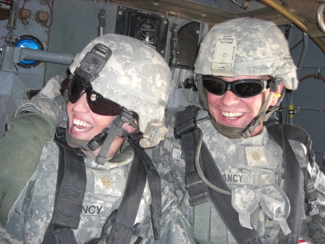 BAGHDAD- Lt. Col. Hailey Clancy, of Mesa, Ariz., (left) and Maj. Michael Clancy, of the Bronx, N.Y., 2nd Brigade Combat Team, 1st Armored Division, Multi-National Division - Baghdad, share a laugh while flying to Camp Striker for a base recon, Aug. 8...