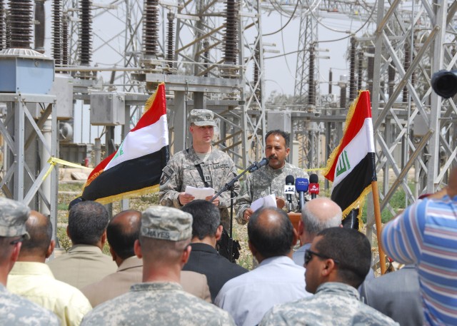 Capt. Jackie Manton, 225th Engineer Brigade, Multi-National Division - Baghdad, speaks to members of the crowd gathered to celebrate the opening of a new feeder line April 8, which provides power to the Agurquf area in the Abu Ghraib district. The...