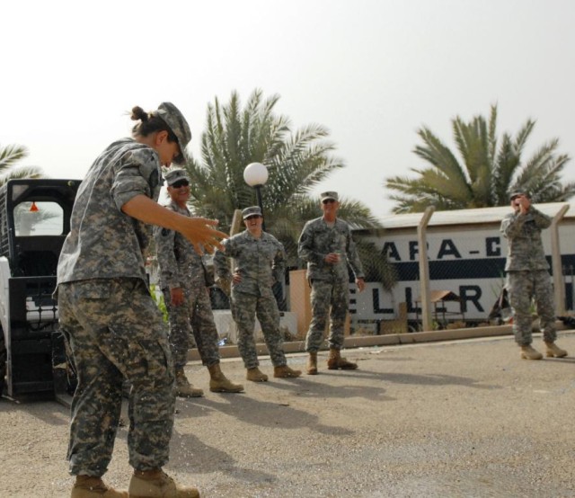 BAGHDAD - The cool water from a broken water balloon quickly cooled off Baton Rouge, La. native, Sgt. 1st Class Karla Allen (left), 225th Engineer Brigade, during an Easter celebration April 12 on Camp Liberty. The 225th Eng. Bde. Soldiers didn't let...