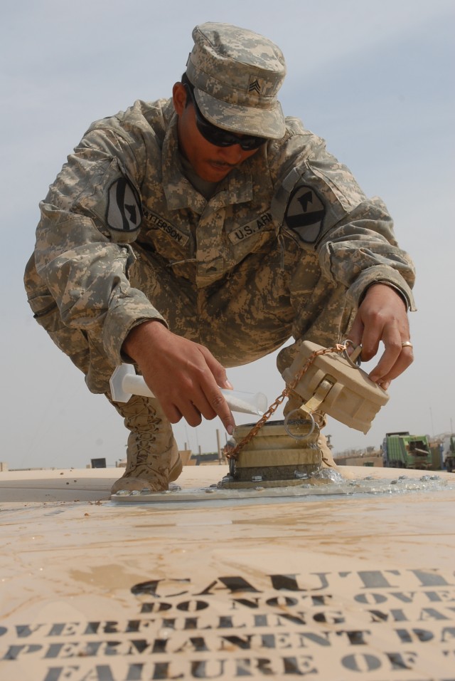 Sgt. Tanarius Patterson, a Shorter, Ala. native and a water purification specialist from Company A, 15th Brigade Support Battalion, 2nd Brigade Combat Team, 1st Cavalry Division, adds chlorine to a 20,000 gallon water holding bag on Forward Operating...