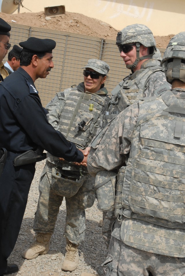 Col. Muhammad Mohsin, the Zaab police chief, shakes hands with Lt. Col. David Lesperance, the commander of 1st Battalion, 8th Cavalry Regiment, 2nd Brigade Combat Team, 1st Cavalry Division, during a validation ceremony held in Hawijah, Iraq,...