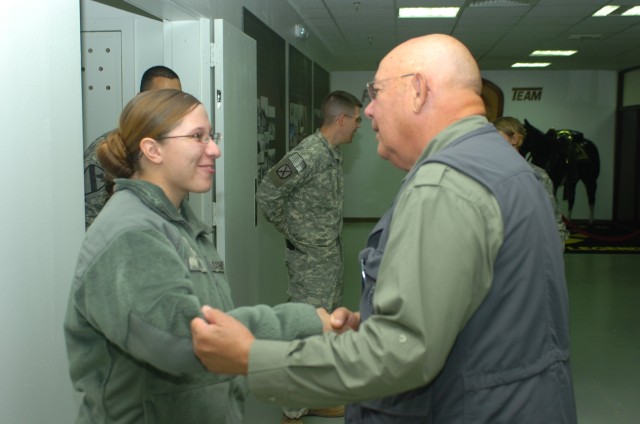 BAGHDAD - During an April 14 visit, Crown Point, Ind. native Pfc. Krystle Rivera (left), a human resource specialist, Company B, Division Special Troops Battalion meets Medal of Honor recipient retired Command Sgt. Maj. Gary L. Littrell at Camp...