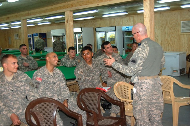 BAGHDAD - Chaplain (Capt) Timothy Meier, MND-B deputy operations chaplain, speaks with Soldiers of the 3rd Brigade Combat Team, 82nd Airborne Division at Joint Security Station Zafaraniyah as he conducts an Easter service April 12 for troops that...