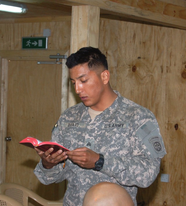 BAGHDAD - Sgt. Francisco Bravo, a Soldier with Battery A, 1st Battalion, 319th Field Artillery, reads a Bible passage as part of the Easter services conducted at Joint Security Station Zafaraniyah. MND-B chaplains convoyed to different JSS...