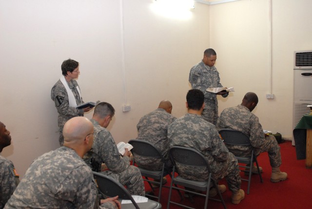 BAGHDAD - Sgt. 1st Class Martin Rosenfeld of the 42nd Brigade Iraqi Army Military Transition Team reads a Bible passage during Easter services at Joint Security Station Old MOD (Ministry of Defense). Chaplain (Lt. Col.) Barbara Sherer involved...