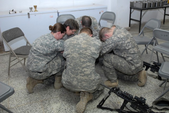 BAGHDAD - Soldiers of Company B, 2nd Battalion, 505th Parachute Infantry Regiment at Joint Security Station Hope gather in prayer with Chaplain (Lt. Col.) Barbara Sherer after receiving Easter communion. JSS Hope was the last of four stations two...