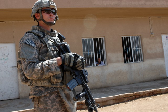 BAGHDAD - Anadarko, Okla., native, Staff Sgt. Tim Winn, a section sergeant cavalry scout assigned to 1st Squadron, 7th Cavalry Regiment, visits a school in Boob al-Sham here, April 13, which has been operating since 1990. The headmaster for the...