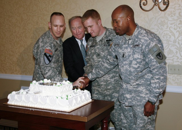 PICATINNY ARSENAL, N.J. - Command Sgt. Maj. Rodney Rhoades (from left), U.S. Rep. Rodney P. Frelinghuysen, Cpl. Sean Brennan and Command Sgt. Maj. Larry Taylor participate in a time-honored tradition by using an NCO sword to cut a cake at a...