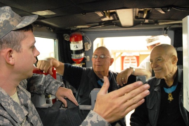 BAGHDAD - Waco, Texas native, Pfc. Andrew Lundy, 515th Engineer Company, 225th Engineer Brigade, demonstrates the common remotely operated weapons system to Medal of Honor recipients, retired Command Sgt. Maj. Gary Littrell (center) and retired Col. ...