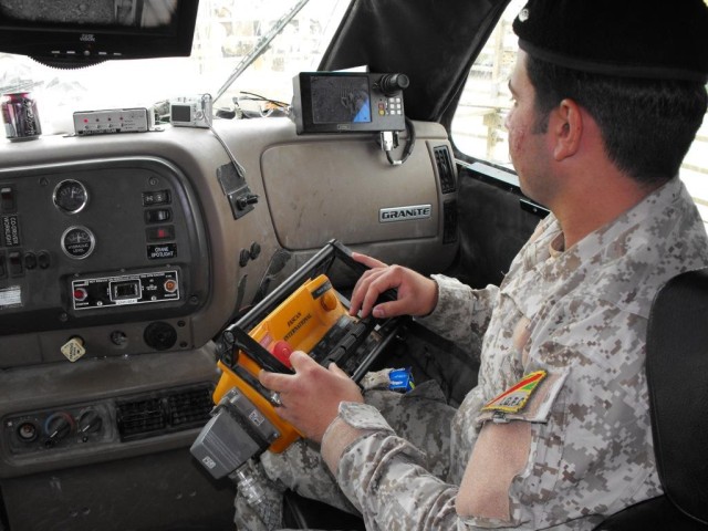 Iraqi Army Jundee Aly Saleh learns how to use the joystick to operate the long arm of the armored Buffalo truck during training operations April 15 at Al Rasheed. "The training is good information that we never have used before," said Saleh.  Soldier...