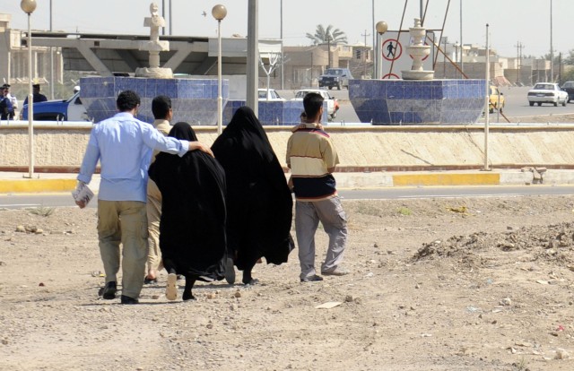 BAGHDAD-A former detainee puts his arm around a family member as they walk towards their home in the Doura area of Baghdad shortly after the conclusion of a reconciliation ceremony at Joint Security Station Doura, April 13. Twelve former detainees...