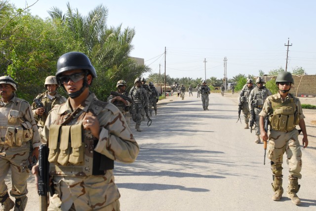 BAGHDAD - Iraqi Army Soldiers from 2nd Battalion, 23rd Brigade, 17th Iraqi Army Division, march with troops from Company A, 1st Combined Arms Battalion, 63rd Armor Regiment, on a dismounted patrol during Operation Bein Al-Nahrein April 13. The combin...