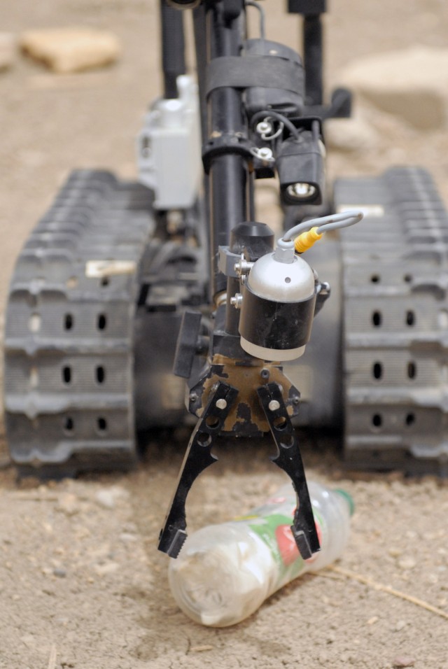 BAGHDAD - The Talon robot, being controlled by a member of the 17th Iraqi Army Engineer Regiment, picks up an empty bottle with its grippers during a joint training exercise located at Joint Security Station Deason, in southern Baghdad, April 16....