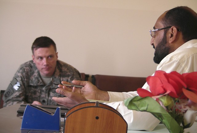 AL-MADAIN, Iraq - Sa'ad Salmin, the Al-Madain community sports chairman, talks with Lt. Col. Michael Shinners, of Alexandria, Va., during a site assessment mission April 18 in the Al-Madain area of eastern Baghdad. Shinners, the deputy commander...