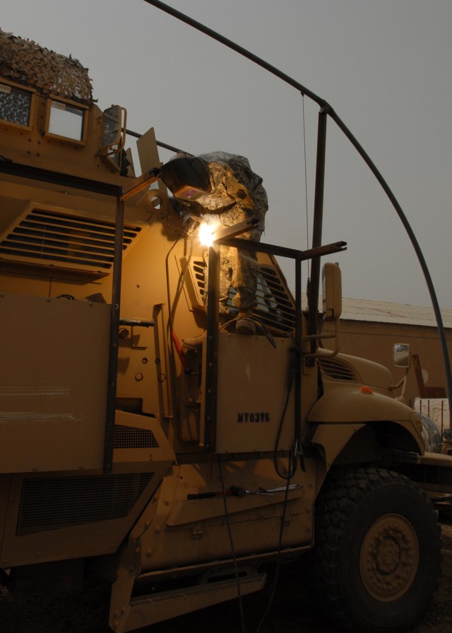 BAGHDAD - Spc. Richard Pfleegor of Jersey Shore, Pa., a Soldier with Company B, 328th Brigade Support Battalion, 56th Stryker Brigade Combat Team, welds outriggers onto a bolt-on metal frame April 16. The frame is the support for a Hesco mesh wire ap...