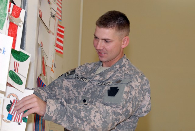 BAGHDAD- Spc. Matthew Fogarty, a native of Bethleham, Pa., and a cavalry scout in B Troop, 2nd Squadron, 104th Cavalry Regiment, 56th Stryker Brigade Combat Team hangs cards from the students of the Anne G. McGuinness Intermediate School of Union...