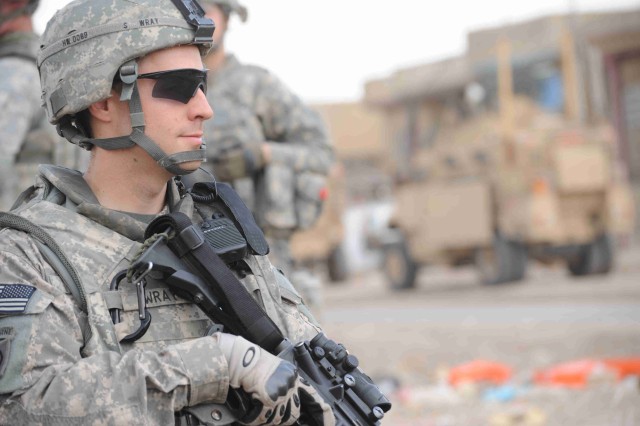 BAGHDAD - Sgt. Nathaniel Wray, of Troutdale, Ore., provides security near a soccer field during a site assessment mission April 18 in the al-Madain area of eastern Baghdad. Wray, a team leader assigned to the Headquarters and Headquarters Company, 3r...