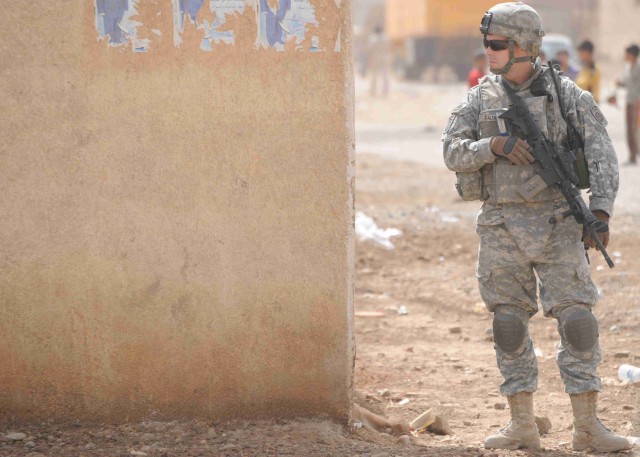 BAGHDAD - Sgt. John Palmer, of Dacula, Ga., secures an area during a site assessment mission April 18 in the al-Madain area of eastern Baghdad. Palmer, a team leader assigned to the Headquarters and Headquarters Company, 3rd Brigade Combat Team, 82nd...