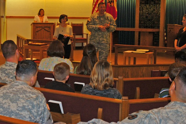 Col. Larry Phelps, the commander of the 15th Sustainment Brigade, 13th Sustainment Command (Expeditionary), talks to Soldiers and Family members at the command's Chapel April 14. The brigade recognized 10 outstanding volunteers, including the brigade...