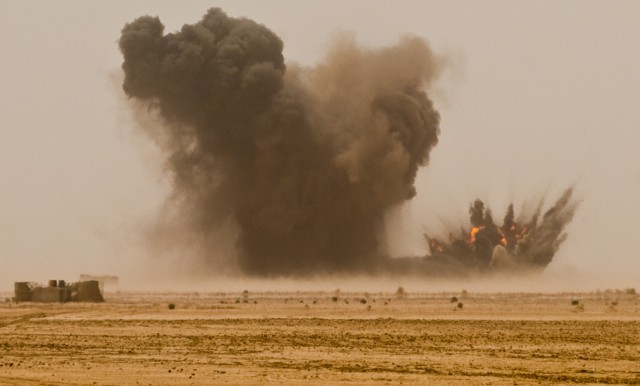 A pair of 500-pound Joint Direct Attack Munition bombs explode on the impact site of the 10th Iraqi Army Division's and Long Knife Brigade's combined arms live-fire exercise in the Maysan province April 19. A pair of U.S. Air Force fighter jets...