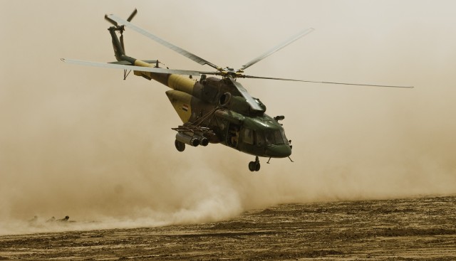 An Iraqi Air Force utility helicopter takes off after inserting ground troops onto the mock battlefield of the combined arms live-fire exercise in the Maysan province April 19. The event displayed the combined forces of the 10th Iraqi Army...