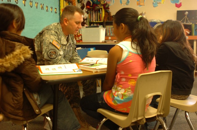 Staff Sgt. Mattern Matthew, 3rd Brigade Special Troops Battalion, 3rd Heavy Brigade Combat Team, 1st Cavalry Division, Rear Detachment from Meadville, Pa., reads with third graders April 20, through the battalion's Adopt-A-School program at...