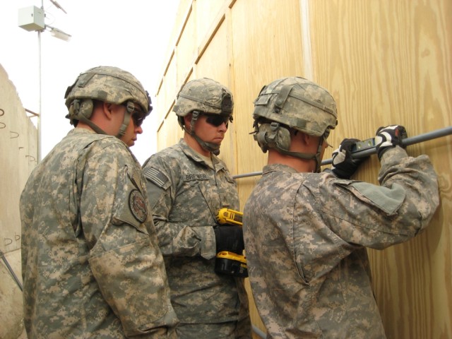 BAGHDAD - Using a level, Spc. Johannes Cawood, from Flint, Mich., Sgt. Cole Brewer, from Riverside, Calif., and Sgt. Ronald Headley, from Birmingham, Ala., 46th Engineer Combat Battalion (Heavy), 225th Engineer Brigade, make sure the main supply...