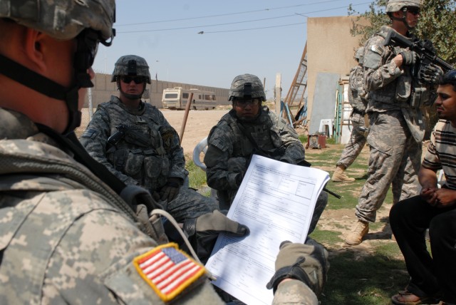 Spc. Adam Jolliff, a native of San Angelo, Texas, and a cavalry scout intelligence support specialist assigned to Apache Troop, 1st Squadron, 7th Cavalry Regiment, holds the paperwork needed in order to request a micro-grant. Jolliff is working on...