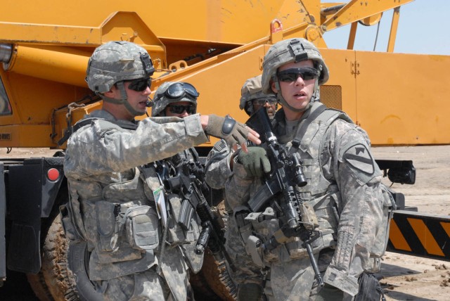 HUSSENIYAH, Iraq - West Point, N.Y. native, 1st Lt. Aaron Shittack (left), platoon leader for B Troop, 1st Squadron, 7th Cavalry Regiment, and Birmingham, Ala. native, Cpl. Thomas Robbins (right), the senior line medic for Blackhawk Troop access...