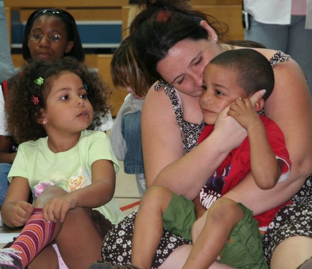 Maria Ross and her children Darren, right, and Destiny, left, enjoy the School Age Services Junior Idol competition, one of SAS's events honoring Month of the Military Child. Ross's children and the children at U.S. Army Garrison Hohenfels...
