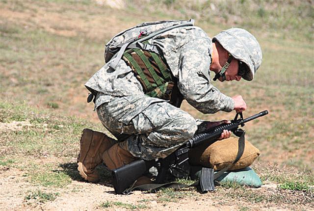 Sgt. Bret Cherry, a wound warrior adjusts his M-16 rifle
