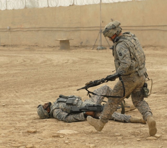 BAGHDAD - Sgt. Jose Leasure, the sergeant of the guard at an entry control point on Victory Base Complex and native of Brunswick, Ga., serving with Troop A, 1st Squadron, 124th Cavalry Regiment, 56th Infantry Brigade Combat Team,  reacts to a wounded...