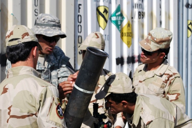 BAGHDAD - Tomsham, Maine native, Staff Sgt. Matthew St. Pierre, mortar platoon sergeant for 1st Battalion, 5th Cavalry Regiment, 1st Brigade Combat Team, 1st Cavalry Division demonstrates to the mortar battery from the 42nd Iraqi Army Brigade the pro...