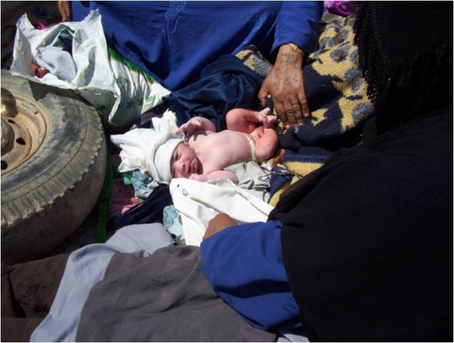 A new baby boy opens his eyes for the first time after being delivered with the assistance of U.S. Army medics near Dalish, Iraq, April 21. Spc. Nicholas Martin and Pfc. Michael Guerrero, both medics with 4th Squadron, 9th Cavalry Regiment, 2nd...