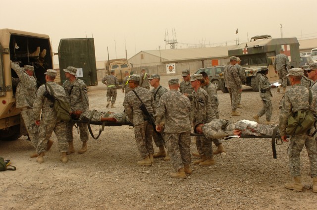 BAGHDAD - Soldiers from the Division Special Troops Battalion, 1st Cavalry Division, Multi-National Division-Baghdad, move simulated casualties to an ambulance during a mass casualty exercise on Camp Liberty April 24. The First Team troopers...