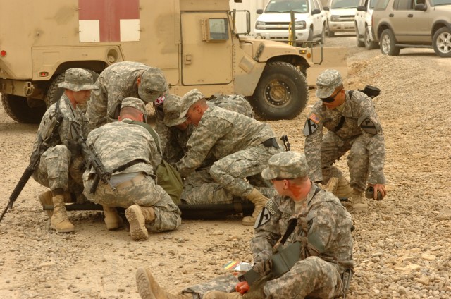 BAGHDAD-While some Division Special Troop Battalion, 1st Cavalry Division,  Multi-National Division-Baghdad Soldiers at Camp Liberty act as simulated casualties, other DSTB Soldiers work as medics and combat lifesavers, rushing to treat their...